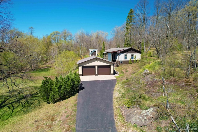 view of front of home with a detached garage and stucco siding