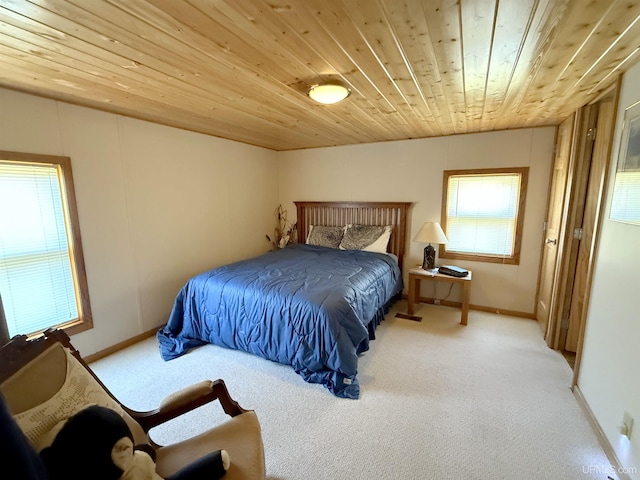 carpeted bedroom with baseboards and wooden ceiling