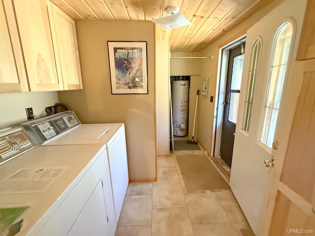 laundry room featuring cabinet space, wooden ceiling, gas water heater, washer and dryer, and light tile patterned flooring