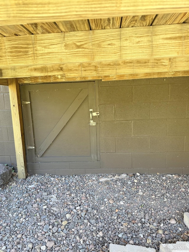 doorway to property with concrete block siding