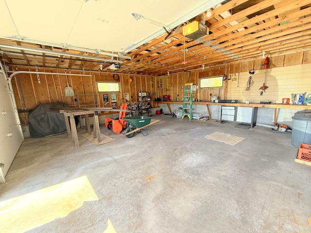 garage featuring a workshop area and a garage door opener