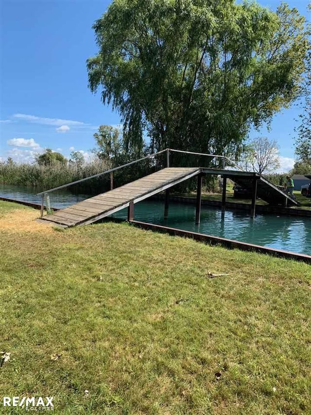 dock featuring a yard and a water view