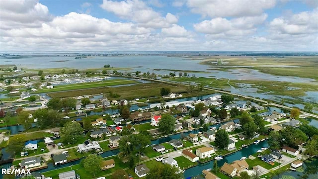 view of property location featuring a large body of water and nearby suburban area