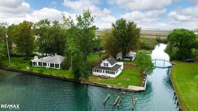 aerial view of property and surrounding area featuring a nearby body of water
