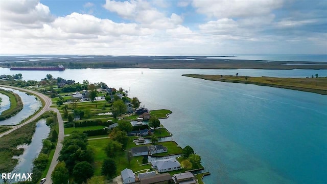 aerial view of property and surrounding area with a large body of water