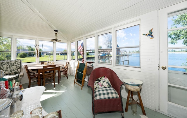 sunroom / solarium with a water view, outdoor dining area, wooden ceiling, wood finished floors, and lofted ceiling
