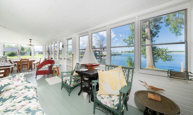 sunroom / solarium featuring a water view, lofted ceiling, wood finished floors, and wood ceiling
