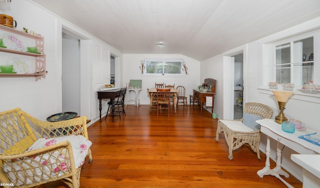 sitting room with wood finished floors and vaulted ceiling