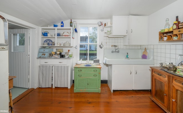 kitchen with open shelves, lofted ceiling, hardwood / wood-style floors, white cabinetry, and radiator heating unit