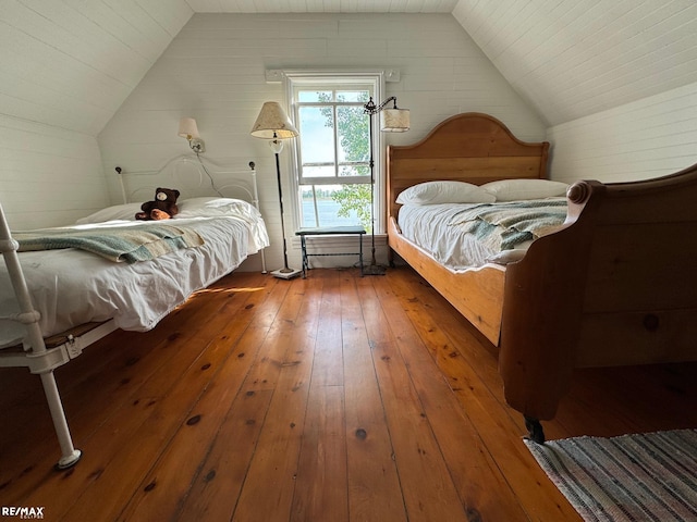 bedroom featuring vaulted ceiling and wood-type flooring