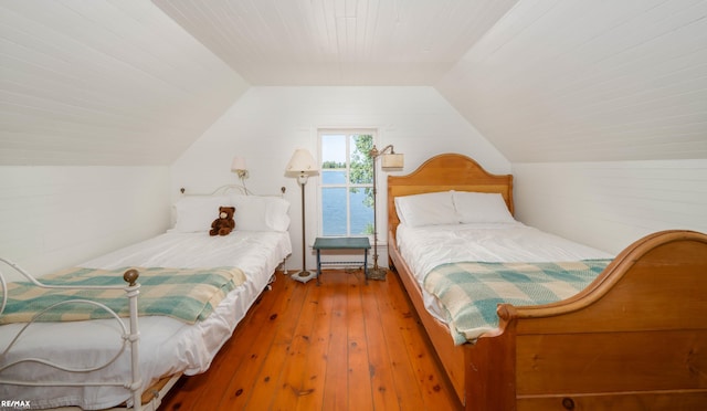 bedroom featuring hardwood / wood-style floors and lofted ceiling