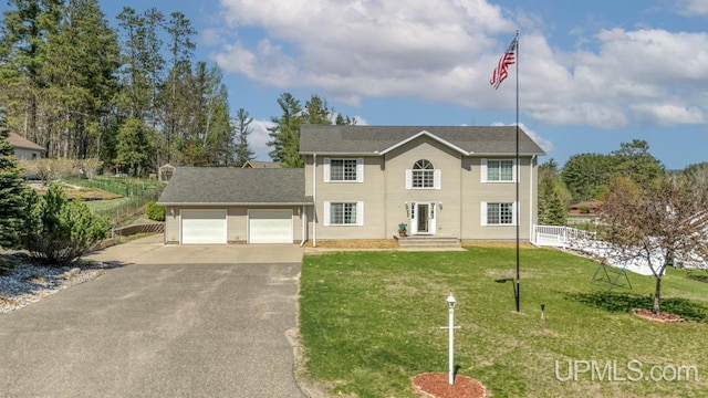 1000 N Evergreen Dr, Iron Mountain, MI 49801 - colonial inspired home featuring asphalt driveway and a garage