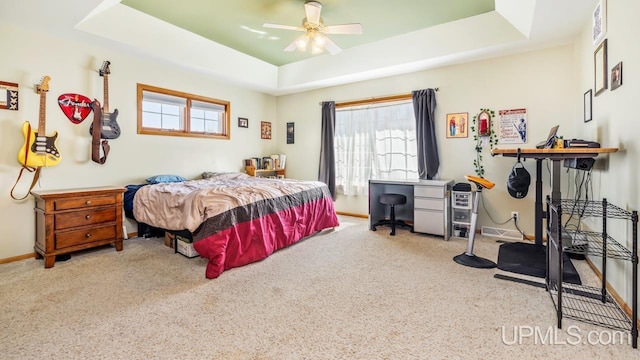 1000 N Evergreen Dr, Iron Mountain, MI 49801 - bedroom with a tray ceiling, carpet, baseboards, a ceiling fan, and an office area