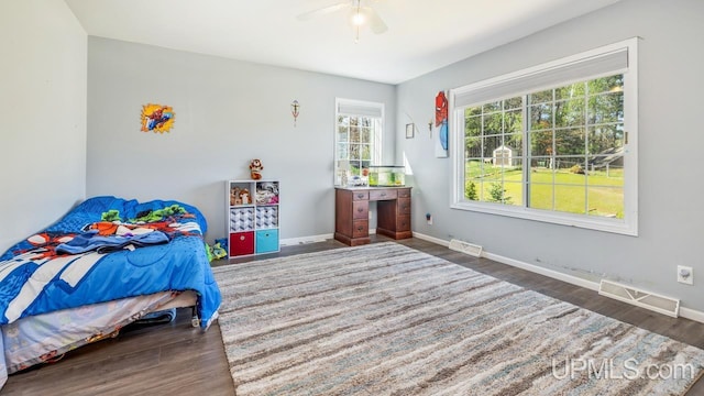 1000 N Evergreen Dr, Iron Mountain, MI 49801 - bedroom with wood finished floors, baseboards, and a ceiling fan