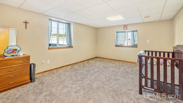 1000 N Evergreen Dr, Iron Mountain, MI 49801 - unfurnished bedroom featuring a paneled ceiling, carpet floors, and baseboards