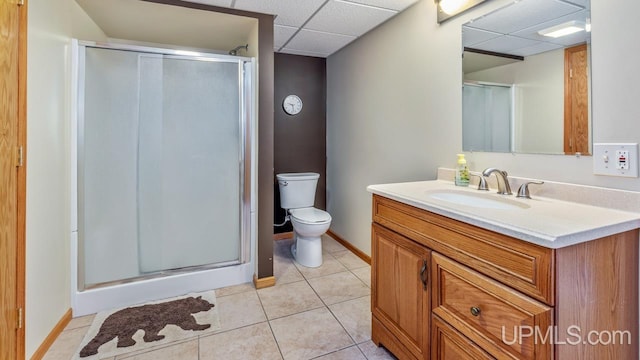 1000 N Evergreen Dr, Iron Mountain, MI 49801 - bathroom with a paneled ceiling, a shower stall, vanity, tile patterned floors, and toilet