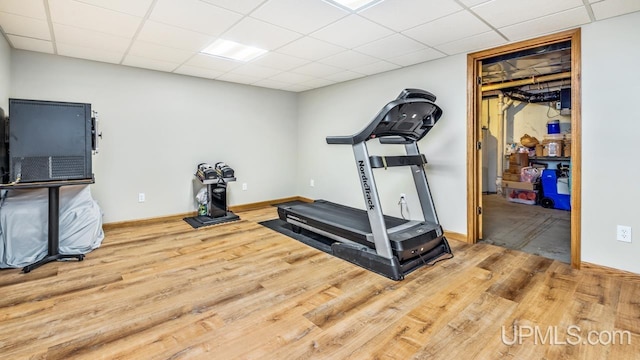 1000 N Evergreen Dr, Iron Mountain, MI 49801 - workout area featuring wood finished floors, a paneled ceiling, and baseboards
