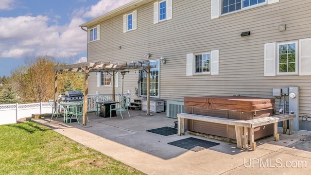 1000 N Evergreen Dr, Iron Mountain, MI 49801 - back of house with a hot tub, a patio, fence, and a pergola