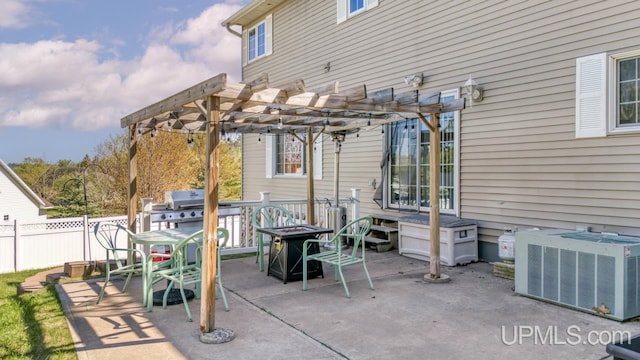 1000 N Evergreen Dr, Iron Mountain, MI 49801 - view of patio with a pergola, central AC unit, an outdoor fire pit, fence, and a grill
