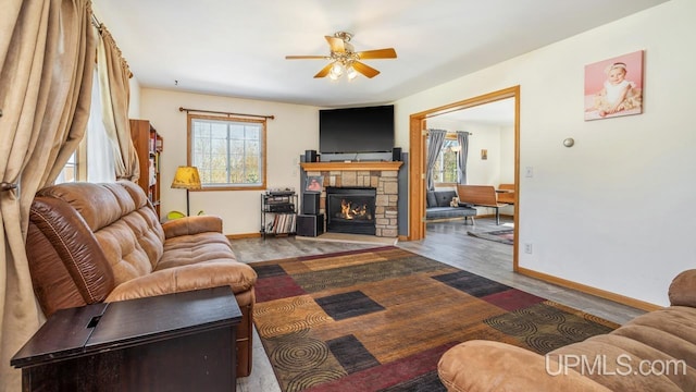 1000 N Evergreen Dr, Iron Mountain, MI 49801 - living area featuring plenty of natural light, a ceiling fan, baseboards, and wood finished floors