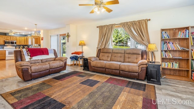 1000 N Evergreen Dr, Iron Mountain, MI 49801 - living room featuring a ceiling fan and plenty of natural light