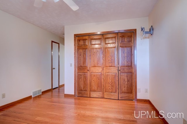 8962 Stagecoach Q.5 Ave, Gladstone, MI 49837 - unfurnished bedroom featuring light wood finished floors, baseboards, and a ceiling fan