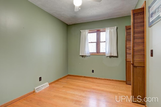 8962 Stagecoach Q.5 Ave, Gladstone, MI 49837 - unfurnished bedroom featuring light wood-type flooring, baseboards, a ceiling fan, and a closet