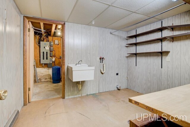 8962 Stagecoach Q.5 Ave, Gladstone, MI 49837 - bathroom featuring electric panel, a sink, a shower, and unfinished concrete flooring
