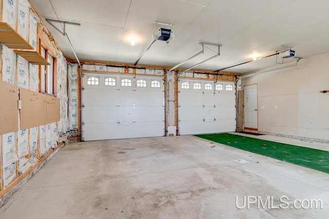8962 Stagecoach Q.5 Ave, Gladstone, MI 49837 - garage featuring a garage door opener