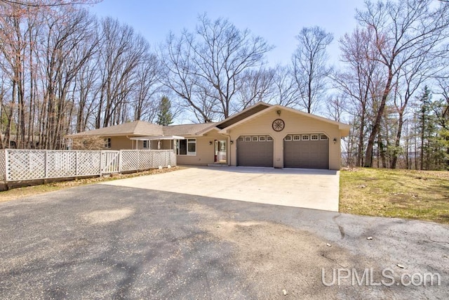 8962 Stagecoach Q.5 Ave, Gladstone, MI 49837 - single story home with a garage, driveway, and fence