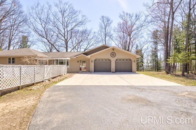 8962 Stagecoach Q.5 Ave, Gladstone, MI 49837 - ranch-style house featuring a garage and driveway