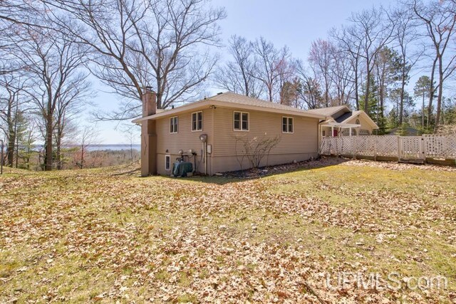 8962 Stagecoach Q.5 Ave, Gladstone, MI 49837 - rear view of property with a chimney and fence