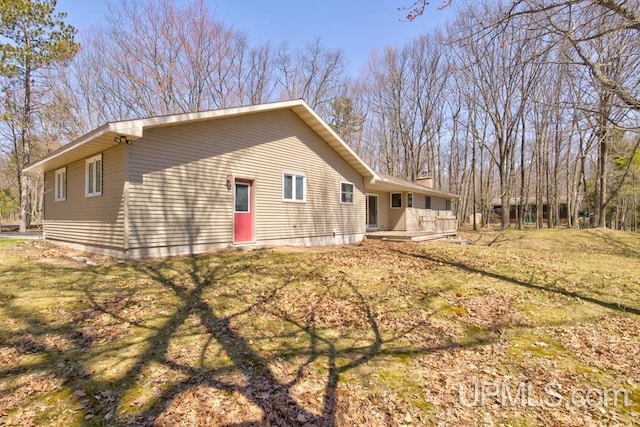 8962 Stagecoach Q.5 Ave, Gladstone, MI 49837 - view of side of home featuring a chimney, a wooden deck, and a yard