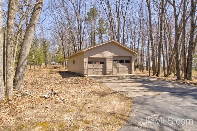 8962 Stagecoach Q.5 Ave, Gladstone, MI 49837 - view of property exterior featuring a detached garage and an outdoor structure