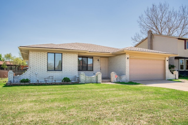 view of front of house with a garage, brick siding, driveway, and a front yard