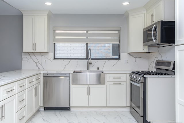 kitchen with stainless steel appliances, a sink, recessed lighting, light stone counters, and tasteful backsplash