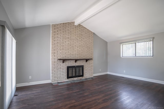 unfurnished living room featuring baseboards, wood finished floors, and a brick fireplace