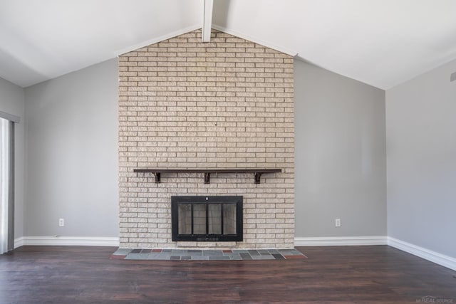unfurnished living room with wood finished floors, a brick fireplace, and baseboards