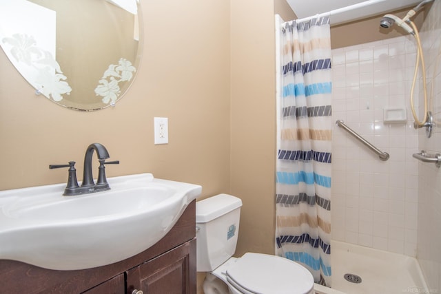 bathroom with a stall shower, toilet, and vanity