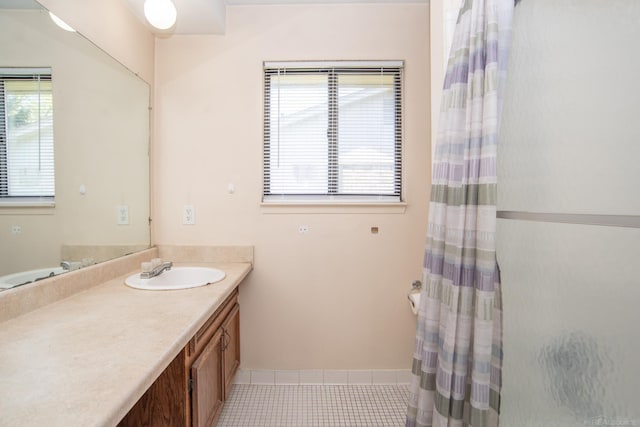 bathroom featuring plenty of natural light, tile patterned floors, a shower with shower curtain, and vanity