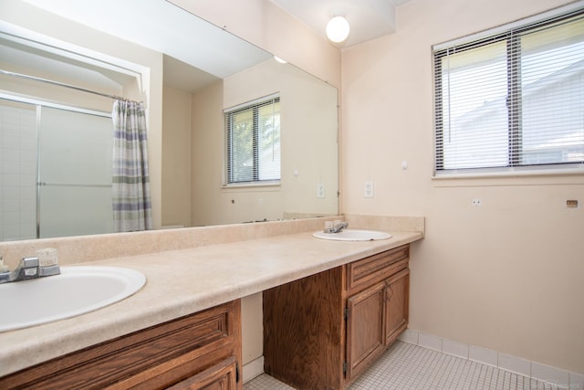 full bathroom with tile patterned flooring, double vanity, a shower with curtain, and baseboards