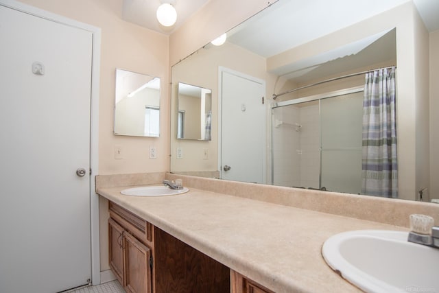 bathroom featuring double vanity and curtained shower