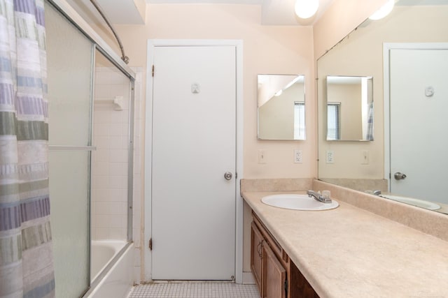 bathroom with vanity, enclosed tub / shower combo, and tile patterned flooring