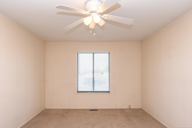 carpeted spare room with ceiling fan