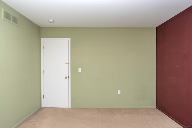 unfurnished room featuring light colored carpet, a smoke detector, and baseboards