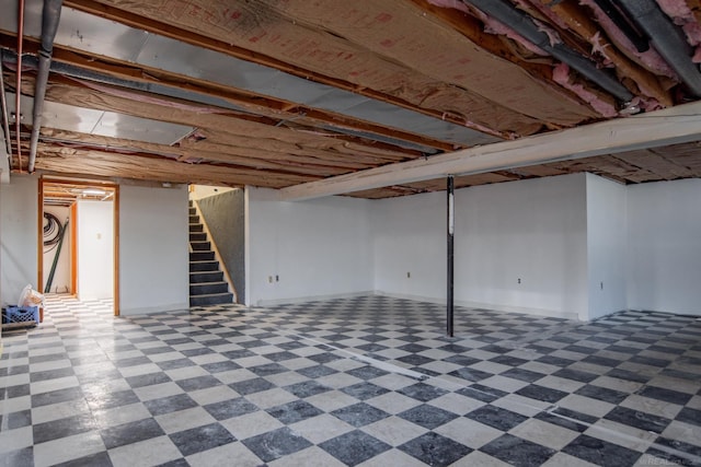 finished below grade area with tile patterned floors and stairway