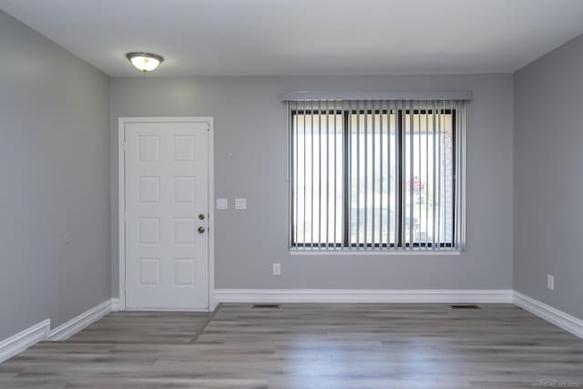 foyer entrance featuring wood finished floors and baseboards