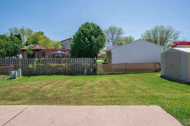 view of yard with a storage shed, an outbuilding, and a pergola