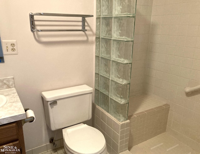 bathroom with toilet, vanity, and walk in shower