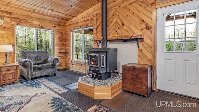 9190 Blue Jay Ln, Florence T-Wi, WI 54121 - living room featuring vaulted ceiling, a wood stove, wooden walls, and wooden ceiling